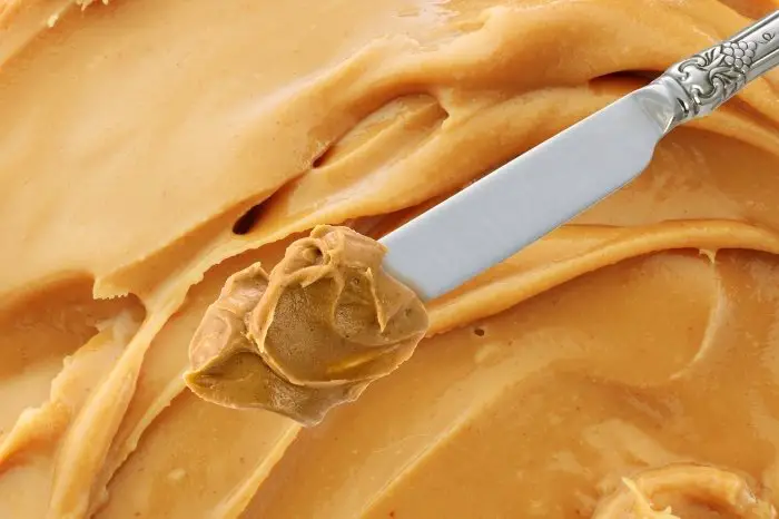 Spread peanut butter over cake